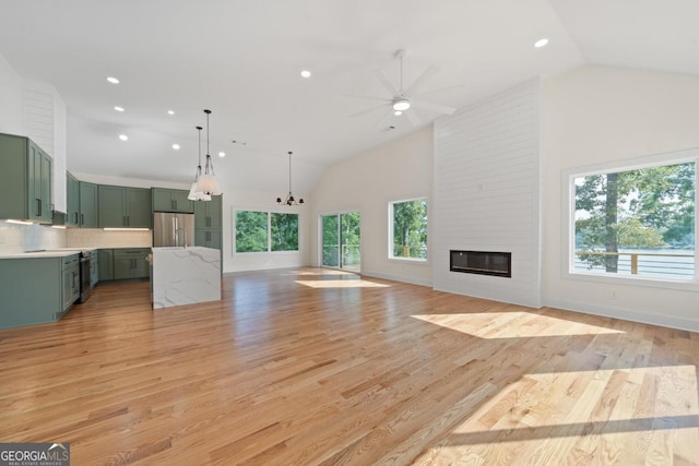 631 Susan Davis Rd, Sparta, GA 31087 - unfurnished living room with ceiling fan, a large fireplace, recessed lighting, light wood-type flooring, and high vaulted ceiling