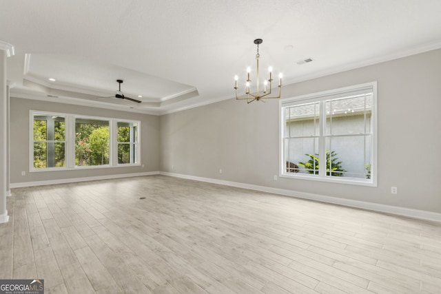 183 Ryan Nicholas Dr, Kingsland, GA 31548 - empty room featuring a raised ceiling, ornamental molding, light wood-style floors, a chandelier, and a ceiling fan
