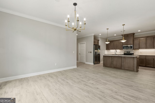 183 Ryan Nicholas Dr, Kingsland, GA 31548 - kitchen with stainless steel appliances, open floor plan, light countertops, recessed lighting, and light wood-style flooring