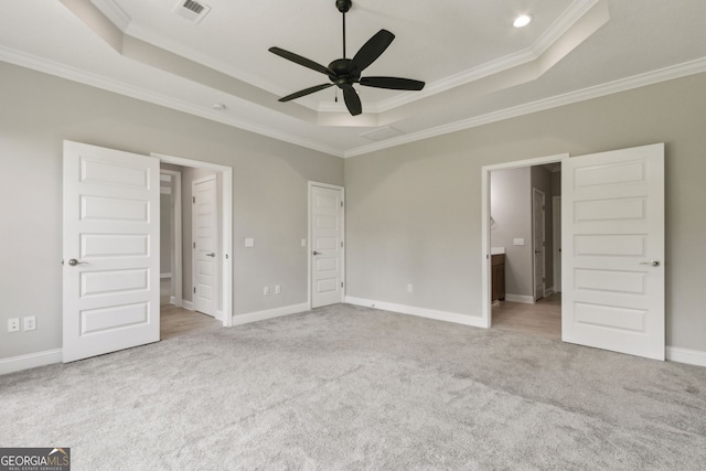 183 Ryan Nicholas Dr, Kingsland, GA 31548 - unfurnished bedroom with a tray ceiling, ornamental molding, carpet flooring, and connected bathroom