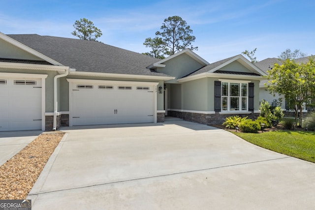 183 Ryan Nicholas Dr, Kingsland, GA 31548 - ranch-style home featuring stone siding, an attached garage, concrete driveway, and stucco siding