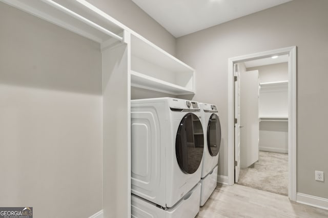 183 Ryan Nicholas Dr, Kingsland, GA 31548 - laundry area featuring washer and clothes dryer and light wood-style floors
