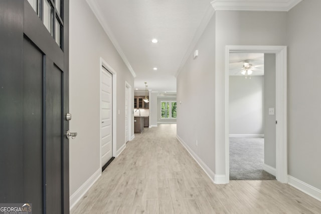 183 Ryan Nicholas Dr, Kingsland, GA 31548 - hallway with light wood-style flooring, ornamental molding, and recessed lighting