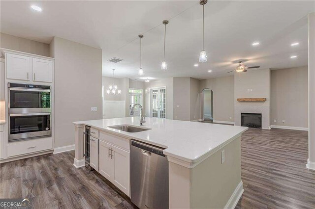 150 Whitworth Dr, Locust Grove, GA 30248 - kitchen featuring stainless steel appliances, ceiling fan, arched walkways, dark wood-type flooring, and recessed lighting