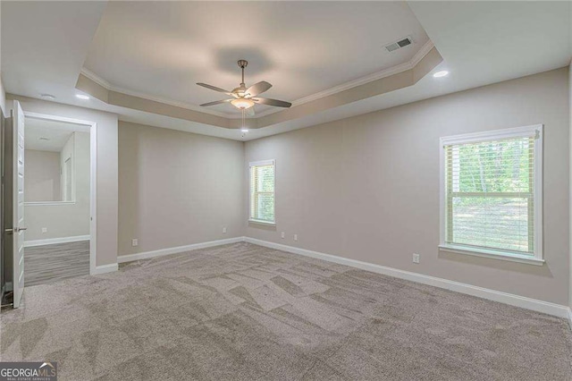150 Whitworth Dr, Locust Grove, GA 30248 - carpeted empty room with ornamental molding, a tray ceiling, a ceiling fan, and recessed lighting