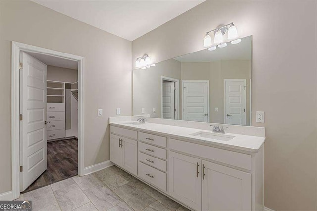 150 Whitworth Dr, Locust Grove, GA 30248 - bathroom featuring double vanity and a spacious closet