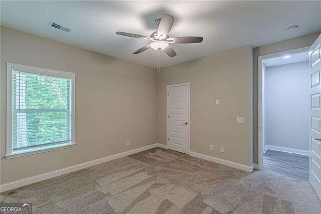 150 Whitworth Dr, Locust Grove, GA 30248 - unfurnished room featuring a ceiling fan, light carpet, and a smoke detector