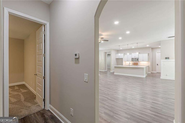 150 Whitworth Dr, Locust Grove, GA 30248 - corridor with light wood-style floors, arched walkways, and recessed lighting