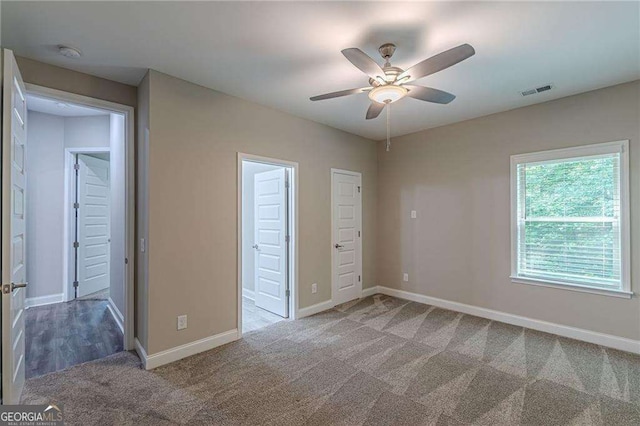 150 Whitworth Dr, Locust Grove, GA 30248 - unfurnished bedroom with carpet floors, ensuite bath, and a ceiling fan