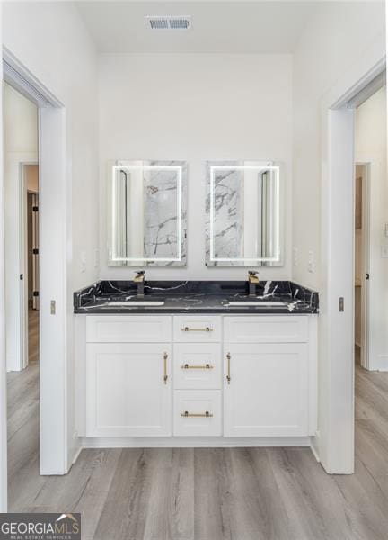 2312 Herring, Atlanta, GA 30311 - full bathroom featuring wood finished floors, double vanity, and a shower
