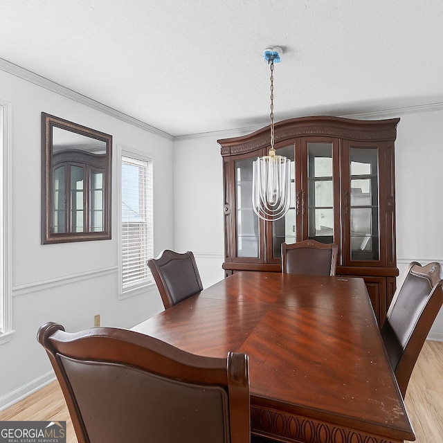 936 Tyrell Dr, Austell, GA 30106 - dining space featuring a chandelier, ornamental molding, and light wood-type flooring