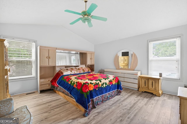 936 Tyrell Dr, Austell, GA 30106 - bedroom with vaulted ceiling, light wood-style flooring, multiple windows, and a ceiling fan