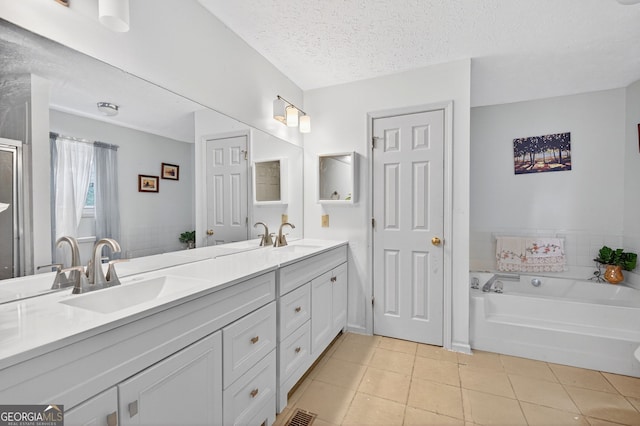 936 Tyrell Dr, Austell, GA 30106 - full bath with tile patterned floors, double vanity, a bath, and a textured ceiling