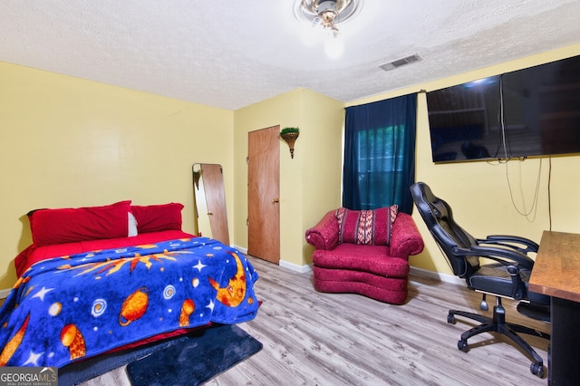 936 Tyrell Dr, Austell, GA 30106 - bedroom featuring wood finished floors, a textured ceiling, and a desk
