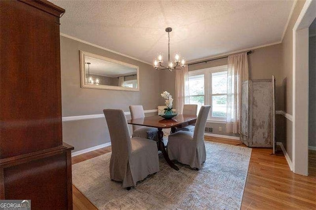160 Edgewood Dr, Athens, GA 30606 - dining room featuring a chandelier, crown molding, wood finished floors, and a textured ceiling