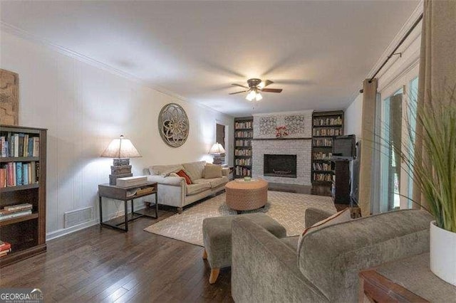 160 Edgewood Dr, Athens, GA 30606 - living room featuring ceiling fan, dark wood-style flooring, a brick fireplace, built in features, and ornamental molding
