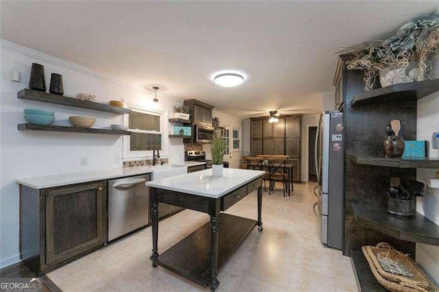 160 Edgewood Dr, Athens, GA 30606 - kitchen with stainless steel appliances, open shelves, light countertops, and crown molding