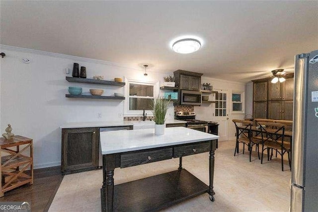 160 Edgewood Dr, Athens, GA 30606 - kitchen with appliances with stainless steel finishes, open shelves, ornamental molding, light countertops, and a ceiling fan