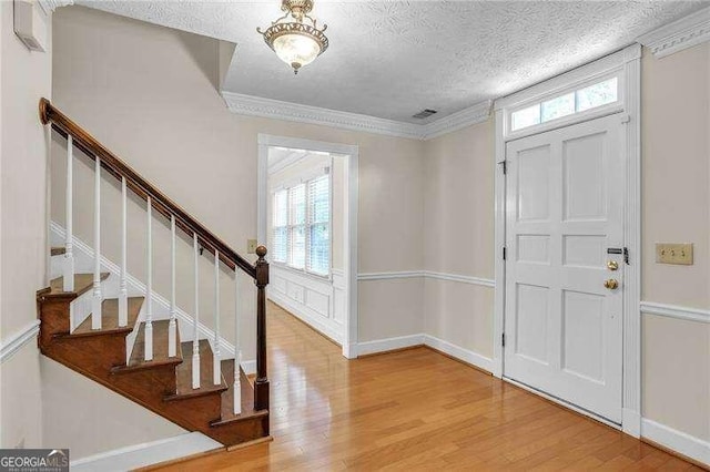 2830 Scottish Mill Way, Marietta, GA 30068 - entryway with wood finished floors, a textured ceiling, stairway, and ornamental molding