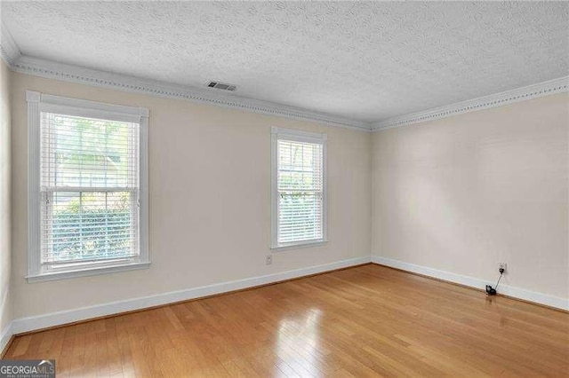 2830 Scottish Mill Way, Marietta, GA 30068 - unfurnished room with plenty of natural light, a textured ceiling, wood finished floors, and crown molding