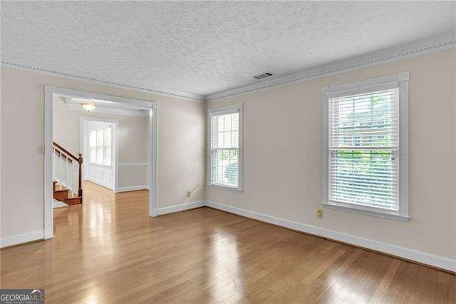 2830 Scottish Mill Way, Marietta, GA 30068 - empty room with crown molding, wood finished floors, a textured ceiling, and stairs