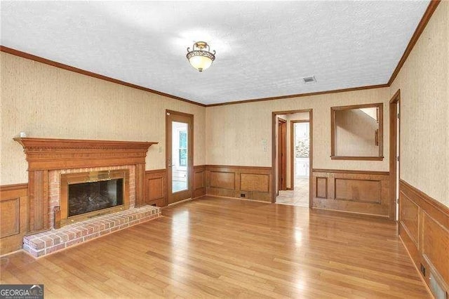 2830 Scottish Mill Way, Marietta, GA 30068 - unfurnished living room featuring wood finished floors, wainscoting, a textured ceiling, a fireplace, and crown molding