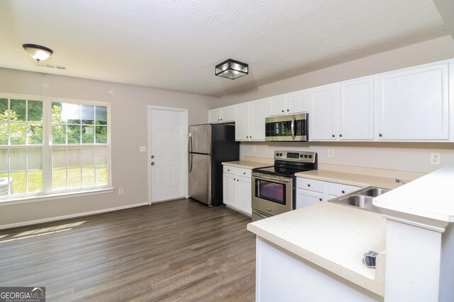 183 Arrowhead Dr, Dallas, GA 30132 - kitchen featuring stainless steel appliances, light countertops, white cabinetry, and a textured ceiling