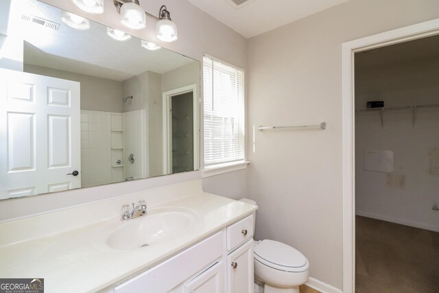 183 Arrowhead Dr, Dallas, GA 30132 - bathroom with vanity, a shower, and a spacious closet