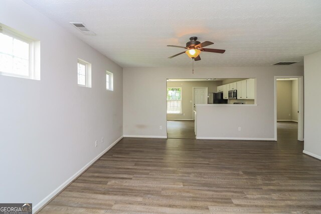 183 Arrowhead Dr, Dallas, GA 30132 - unfurnished living room with ceiling fan, wood finished floors, and a textured ceiling
