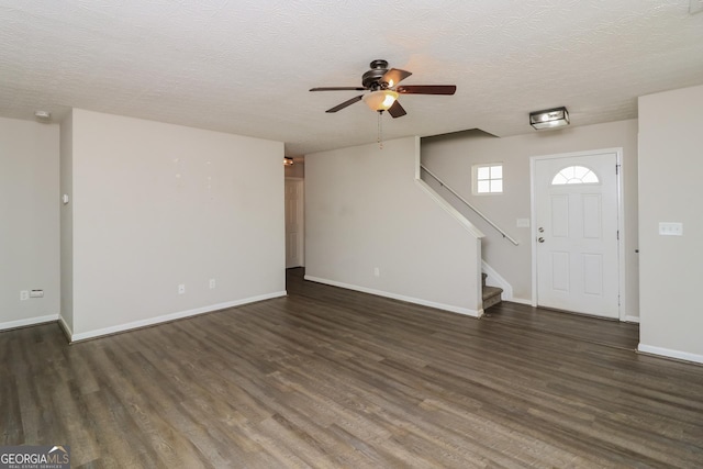 183 Arrowhead Dr, Dallas, GA 30132 - unfurnished living room with ceiling fan, wood finished floors, stairs, and a textured ceiling