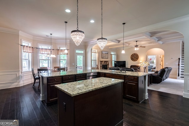 1221 Deer Trl, Bishop, GA 30621 - kitchen featuring a large island with sink, open floor plan, ceiling fan, arched walkways, and dark wood-style flooring