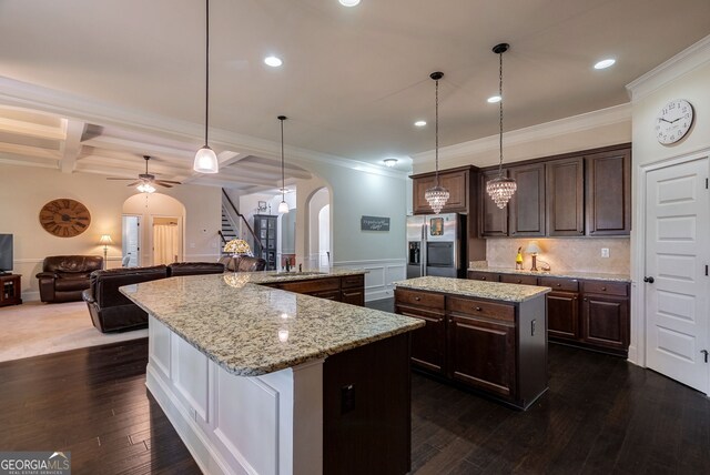 1221 Deer Trl, Bishop, GA 30621 - kitchen with stainless steel refrigerator with ice dispenser, arched walkways, a large island, ornamental molding, and dark brown cabinets