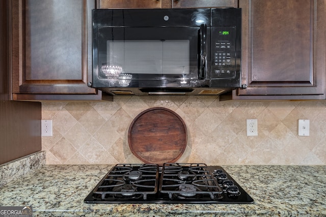 1221 Deer Trl, Bishop, GA 30621 - kitchen view of black appliances, dark brown cabinetry, tasteful backsplash, and light stone countertops