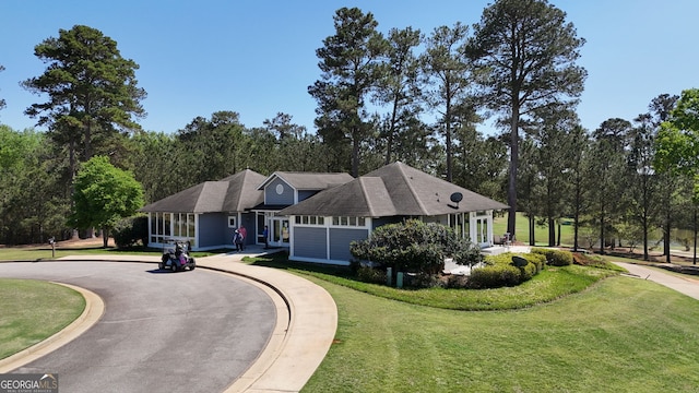 1221 Deer Trl, Bishop, GA 30621 - view of front of property with a front lawn, curved driveway, and view of wooded area