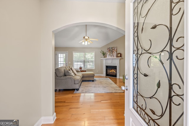 456 Timber Ct, Clarkesville, GA 30523 - living area with a ceiling fan, a lit fireplace, arched walkways, light wood-style floors, and lofted ceiling