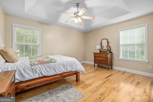 456 Timber Ct, Clarkesville, GA 30523 - bedroom featuring a tray ceiling, light wood-type flooring, and a ceiling fan