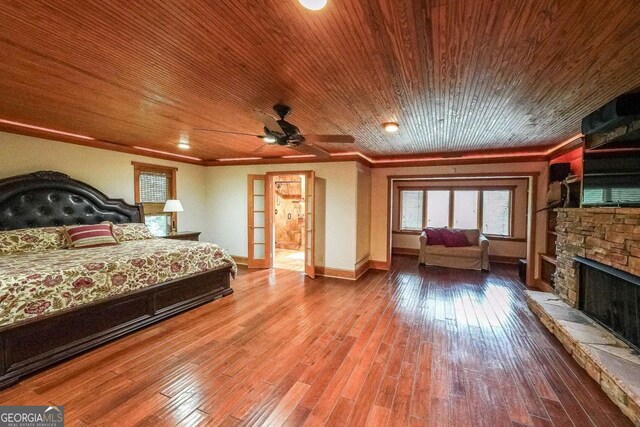 835 Timber Lake Trl, Cumming, GA 30041 - bedroom with a fireplace, wood ceiling, crown molding, and wood finished floors