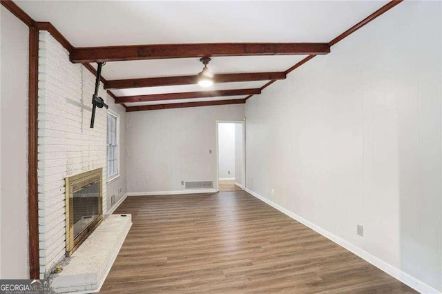 1819 King Alfred Dr SW, Atlanta, GA 30331 - unfurnished living room featuring wood finished floors, beamed ceiling, and a brick fireplace