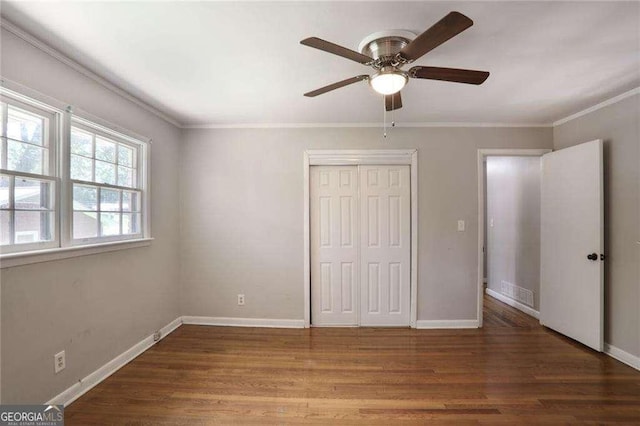 1819 King Alfred Dr SW, Atlanta, GA 30331 - unfurnished bedroom featuring wood finished floors, ornamental molding, a closet, and a ceiling fan