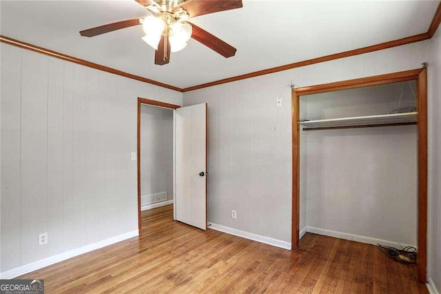 1819 King Alfred Dr SW, Atlanta, GA 30331 - unfurnished bedroom featuring wood finished floors, ornamental molding, a closet, and ceiling fan