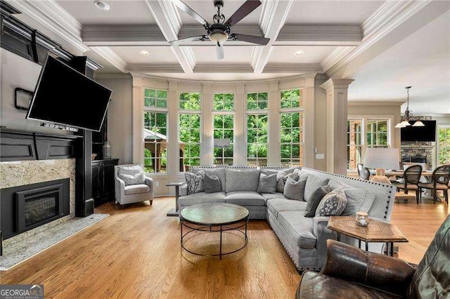 908 Basingstoke Ct, Suwanee, GA 30024 - living area featuring a fireplace, a ceiling fan, crown molding, beamed ceiling, and ornate columns