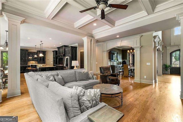 908 Basingstoke Ct, Suwanee, GA 30024 - living area featuring ornate columns, a ceiling fan, arched walkways, beam ceiling, and coffered ceiling