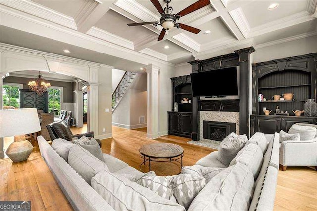 908 Basingstoke Ct, Suwanee, GA 30024 - living room with ornate columns, a chandelier, ornamental molding, a ceiling fan, and coffered ceiling