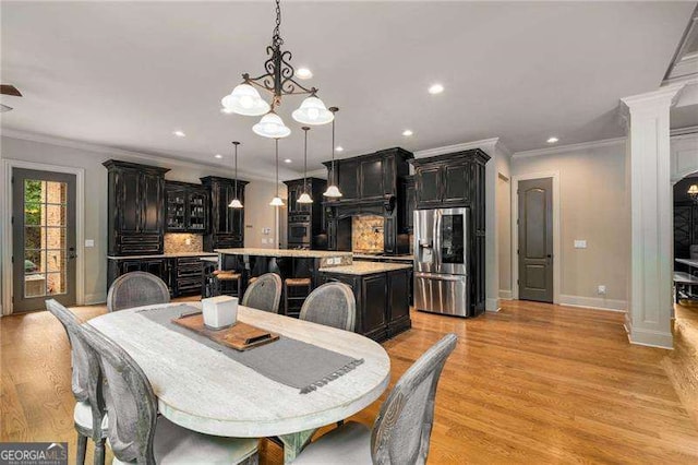 908 Basingstoke Ct, Suwanee, GA 30024 - dining space with crown molding, light wood-style flooring, recessed lighting, and a chandelier