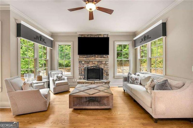 908 Basingstoke Ct, Suwanee, GA 30024 - living area featuring healthy amount of natural light, a fireplace, wood finished floors, and ornamental molding