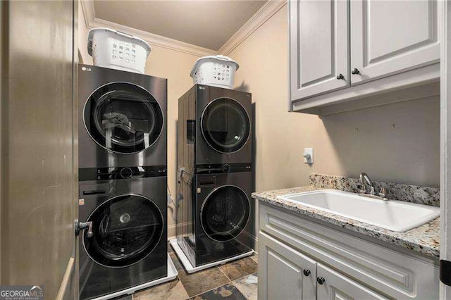908 Basingstoke Ct, Suwanee, GA 30024 - washroom with stacked washer and clothes dryer, ornamental molding, cabinet space, and stone finish floors