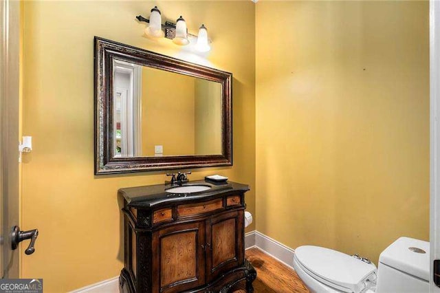 908 Basingstoke Ct, Suwanee, GA 30024 - half bath with vanity and wood finished floors