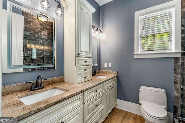 908 Basingstoke Ct, Suwanee, GA 30024 - bathroom featuring double vanity and wood finished floors