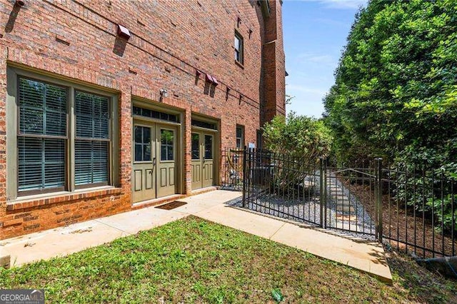 908 Basingstoke Ct, Suwanee, GA 30024 - view of side of home featuring brick siding and french doors