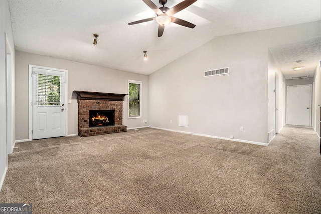 647 Sunshine Trce NW, Acworth, GA 30102 - unfurnished living room featuring ceiling fan, vaulted ceiling, carpet floors, and a brick fireplace